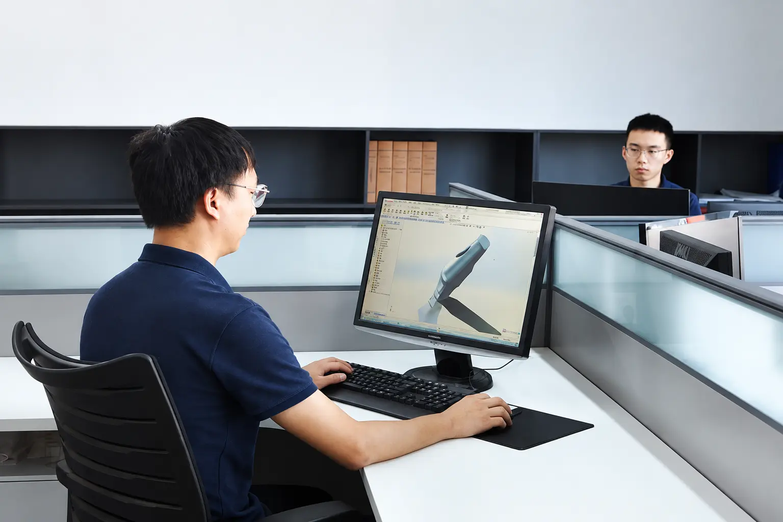 Osstem compatible component design team working with three-dimensional CAD software